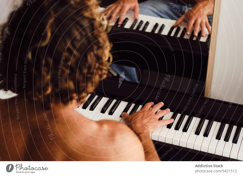 Unrecognizable man playing piano at home rehearsal musician melody instrument practice pianist male skill sound keyboard player entertain artist perform compose
