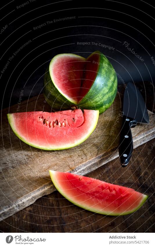 Juicy watermelon on wooden table with knife slice fruit sweet summer delicious ripe fresh food healthy vitamin organic vegan nutrition natural raw piece