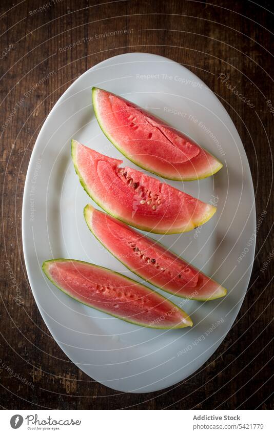 Juicy watermelon on wooden table slice fruit sweet summer delicious ripe fresh food healthy vitamin organic vegan nutrition natural raw piece plate tray