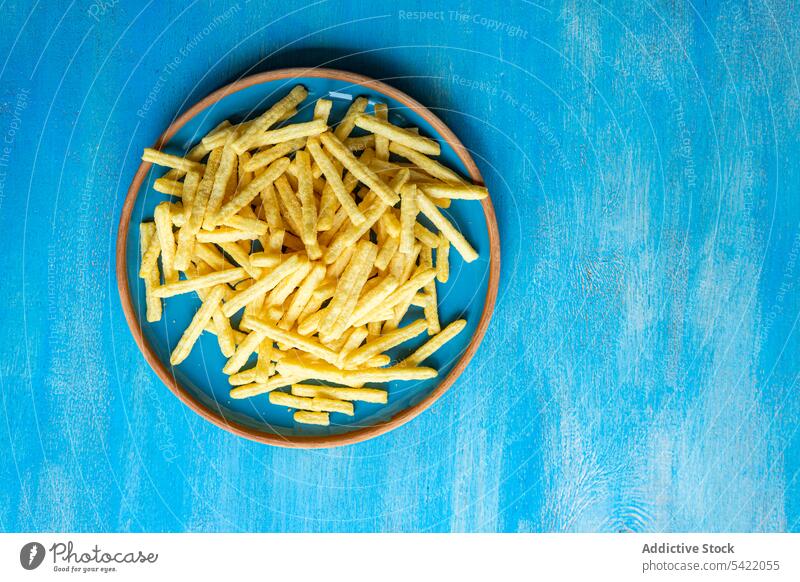 Ceramic plate with French fries french ceramic surface blue high angle from above food dinner meal prepared dish cuisine recipe delicious snack taste tasty eat