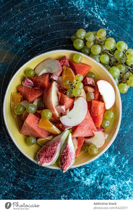 Bowl of fruits seasonal high angle from above surface watermelon grape apple cut fresh food organic colorful design decoration set healthy natural tropical