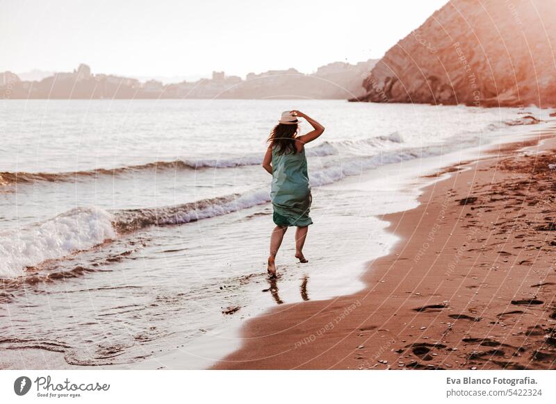 young beautiful woman running by the beach at sunset. Relax and holidays concept cute model shore fresh walk light tourism motion sunlight shine freedom