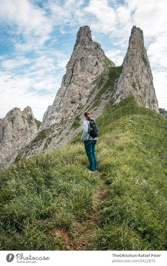 Woman hiking on path in swiss mountains Vantage point Panorama (View) Mountain Sky Clouds Alpstein hiking country appenzellerland Appenzell Grass stones Rock