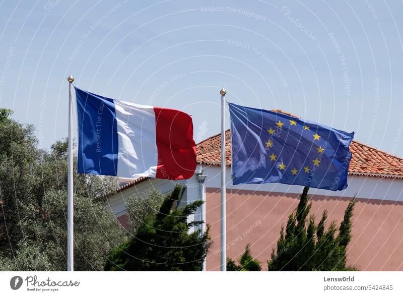 The French national flag next to the European Union flag on a sunny day banner blue cooperation countries country eu euro europe european european union france
