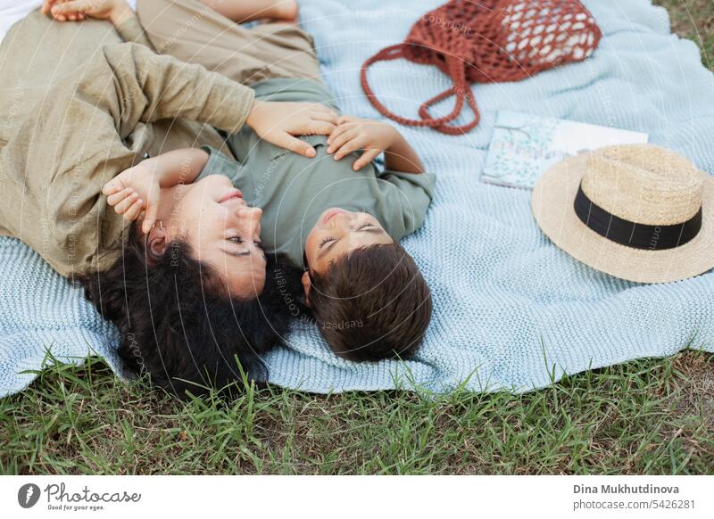 mother and son in the green park in summer on vacation on picnic. Happy family. Mother's Day. Motherhood concept. Boy (child) boy kid childhood mother and child
