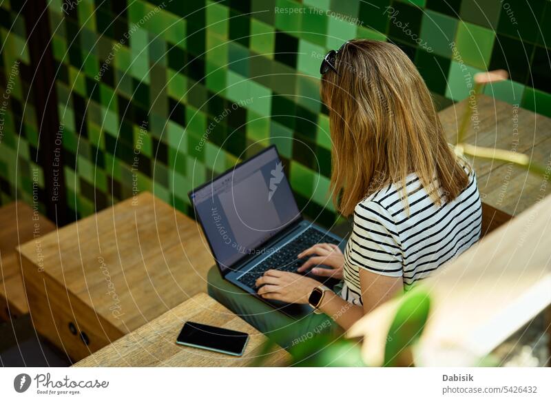 Woman usinf laptop in cafe. Freelancer in coworking use hands freelancer woman business workplace office remote typing people technology computer table