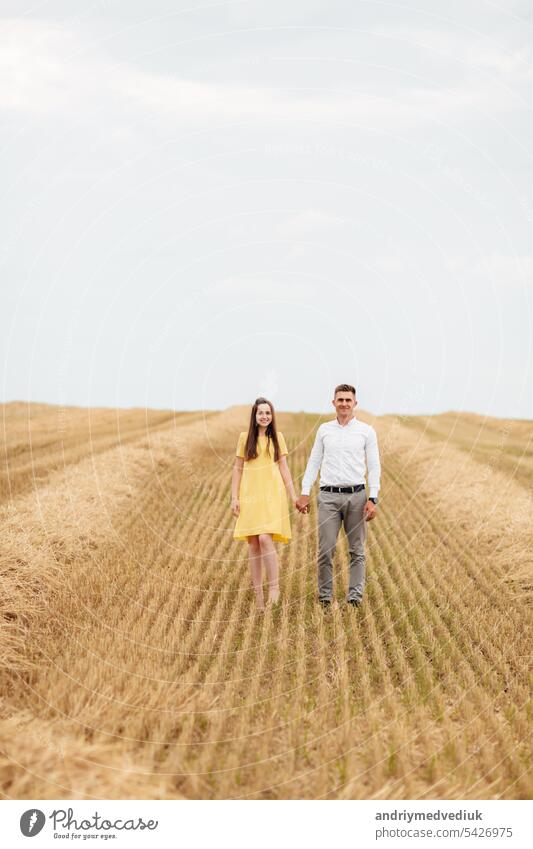 Happy young couple on straw, romantic people concept, beautiful landscape, summer season. love portrait field woman countryside dress haystack rural meadow
