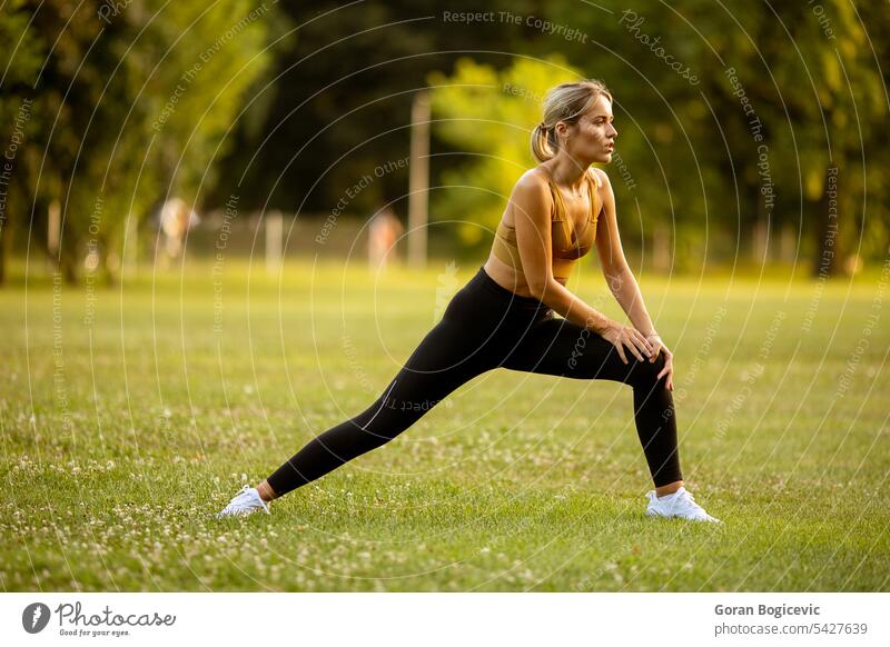 Young woman taking exercises in a park - a Royalty Free Stock Photo from  Photocase