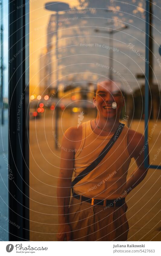 laughing teenager behind orange glass in city Model Orange Slice Fashion Uniqueness urban Town reflection Esthetic pretty 1 Human being Lifestyle portrait