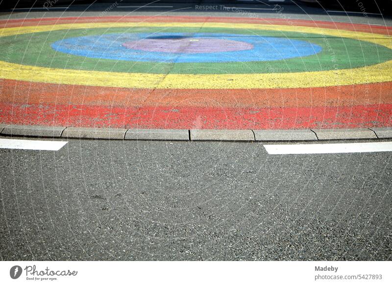 The rainbow traffic circle in rainbow colors with gray asphalt in the sunshine at Vilbeler Straße and Große Friedberger Straße in downtown Frankfurt am Main in Hesse, Germany