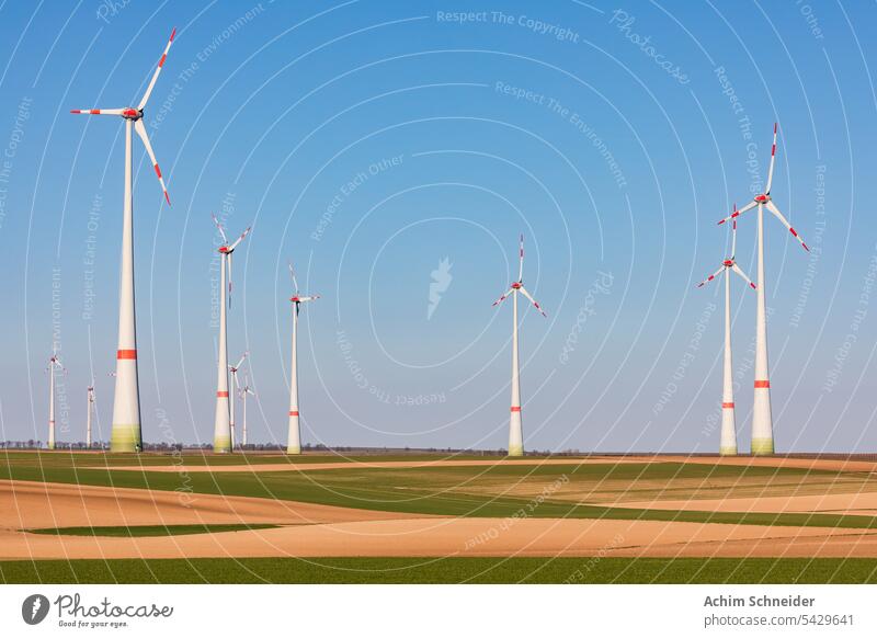The huge towers of a wind farm to generate electricity for the German Energiewende fields energy energy turnaround distant view sky climate change landscape