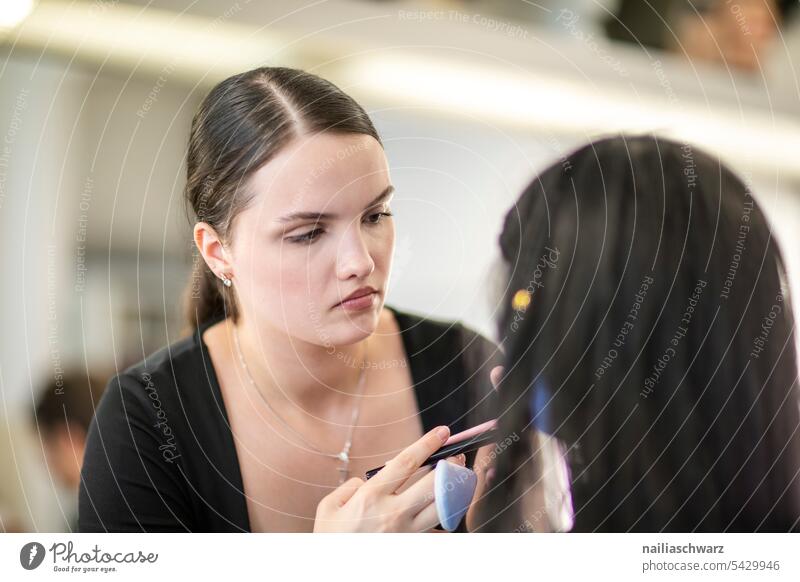 Make up artist at work. Workplace Work and employment beautician make-up reflection Professional training Woman feminine Feminine portrait Face look Dark-haired