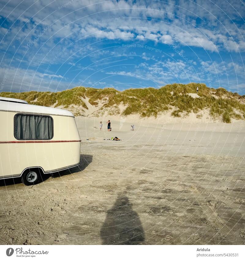 Beach scene | Old caravan, four people and shadow of photographer in front of North Sea dune with dune grass in sunshine Caravan Vacation & Travel Sand duene