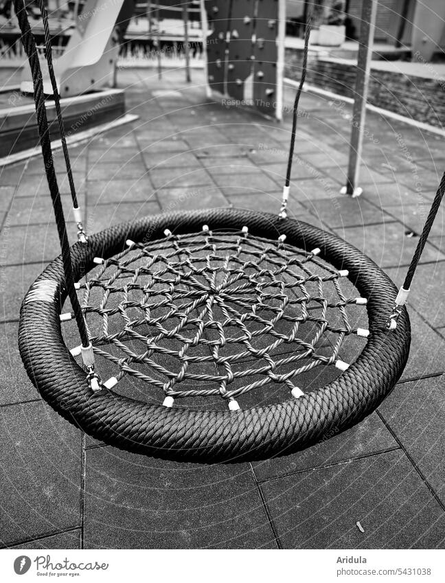 Empty net swing on an orphaned playground b/w Swing Net swing Playground Deserted children children's playground Infancy To swing sad