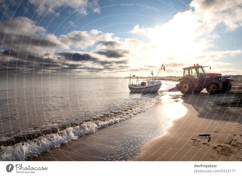 Fishing boat with tractor backlit on Vorupør beach in Denmark at sunrise Sand Colour photo Relaxation Beach life Vacation & Travel bathe Recreation area