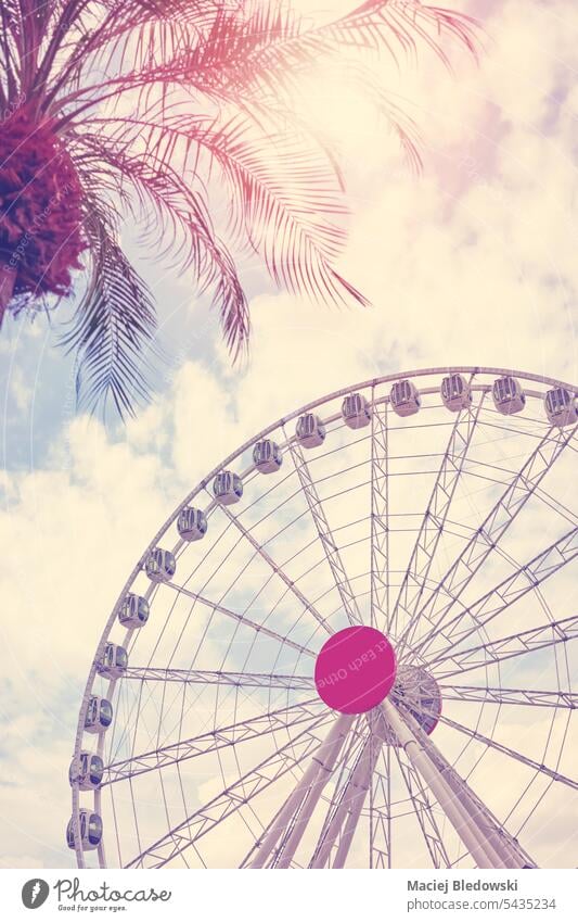 Color toned picture of a Ferris wheel against the sky, color toning applied. park amusement park ferris wheel entertainment fun ride circle summer festival