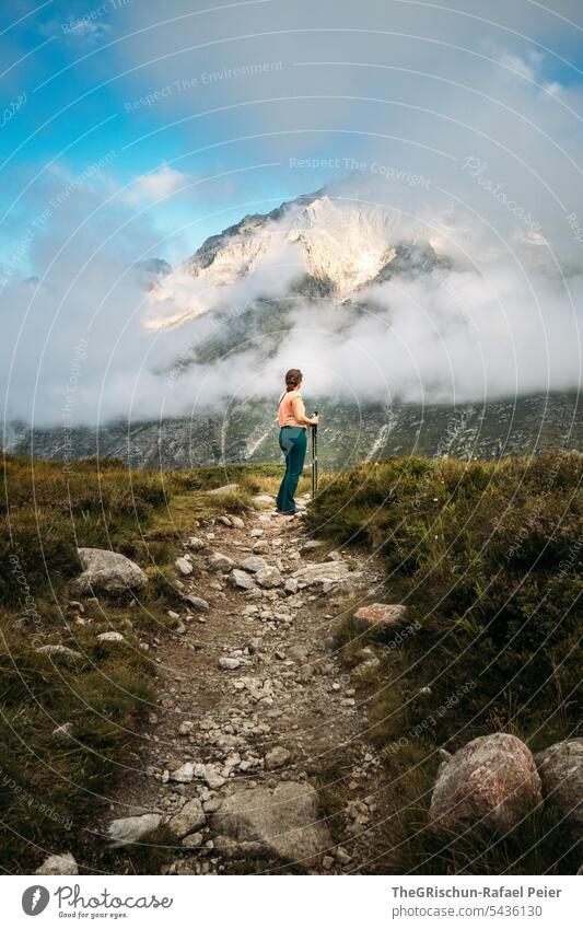 Woman on path in front of mountain Hiking Walking Switzerland Tourism Mountain Landscape Alps Nature Colour photo mountains Vantage point Exterior shot Clouds