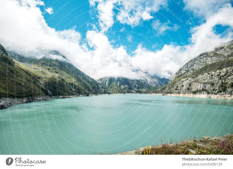 Mountain lake in front of cloud covered mountains Clouds Sky Clouds in the sky Exterior shot Landscape Deserted Colour photo Nature Alps Day Blue Gray rocky