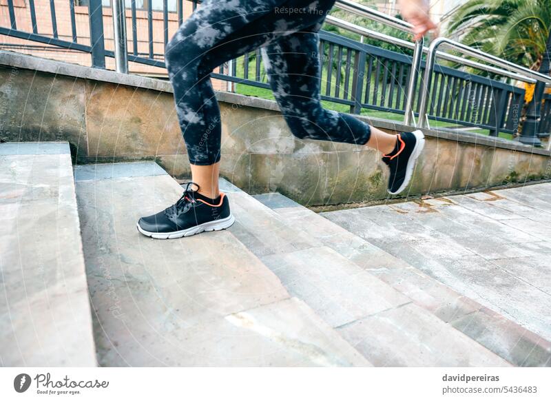 Female legs wearing leggings training running up stairs in town unrecognizable female woman cardio runner staircase step speed action copy space sport strong