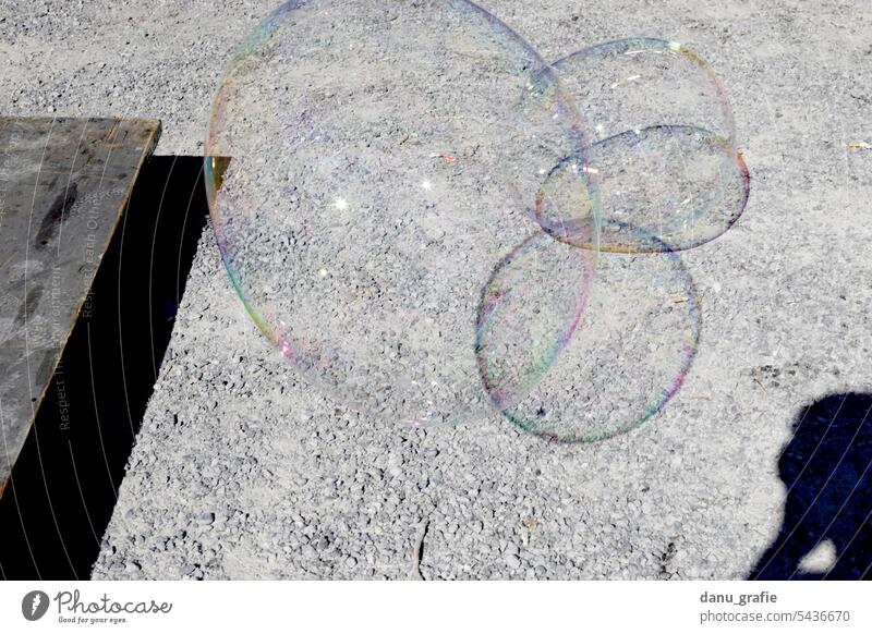 Soap bubbles float in front of gravel floor soap bubbles floating bubbles Transparent Easy Weightlessness Multicoloured Hover Flying Ease Joy Reflection