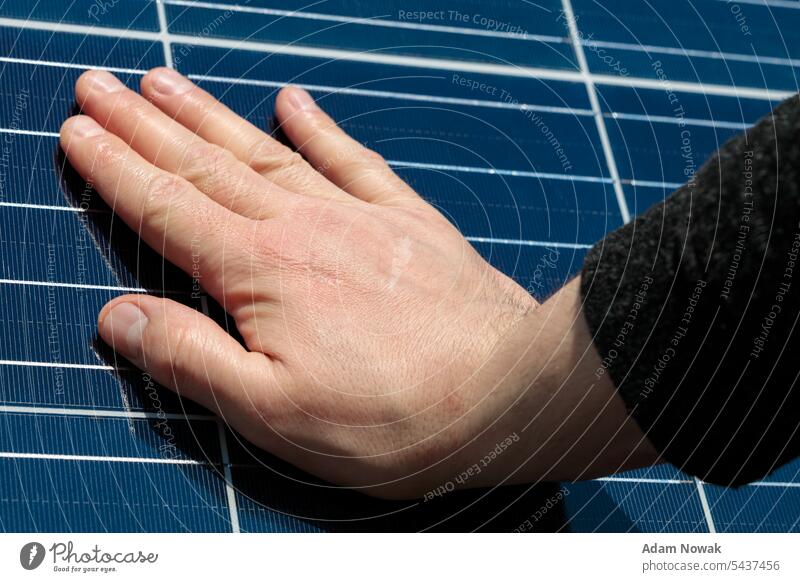 Close up of an engineer hand is checking an operation of sun and cleanliness of photovoltaic solar panels. Concept bio alternative eco business conceptual