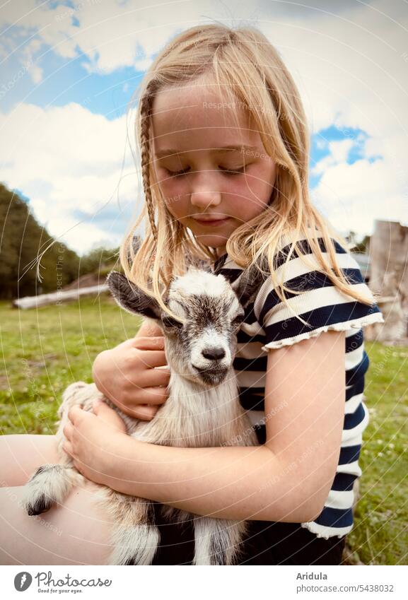 Heidi says hello | girl with little kid on lap goat Child Girl Animal Look after sheltered Caress in the arm Kid (Goat) cautious Wary Pet Farm animal