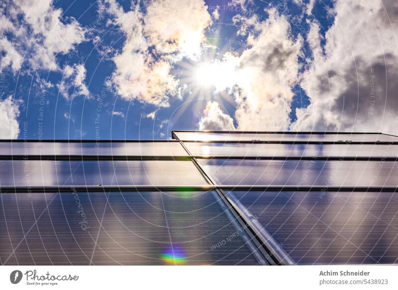 A photovoltaic system on a roof backlit with sun and clouds plant back light solar panels private roof sun star germany efficiency sunset renewable energy sky