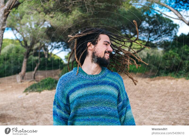 Young man with dreadlocks smiling and shaking his head Puerto Real Shaking Head hair toss Tossing Hair confidence confident style stylish relaxation relaxed