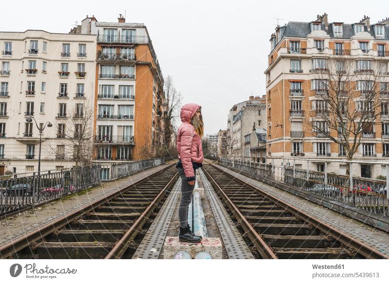 France, Paris, woman standing between abandoned railway tracks Between among females women rails Adults grown-ups grownups adult people persons human being