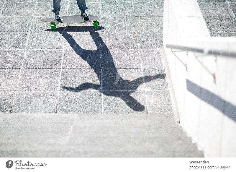 Shadow of a skate boarder on pavement caucasian european caucasian ethnicity caucasian appearance front view head-on frontal head on front views outdoors