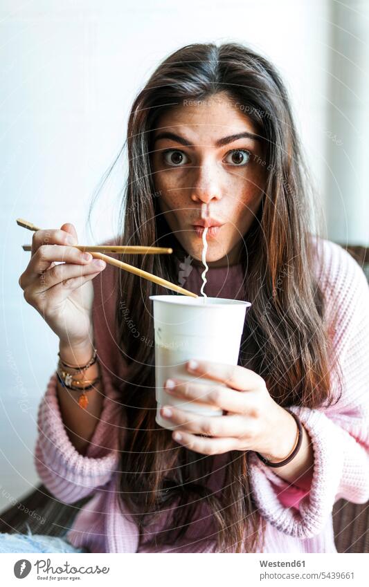 Young woman eating Chinese noodles sipping young women young woman tasty savoury yummy Mouth-watering appetising savory Mouthwatering delicious Noodle Noodles