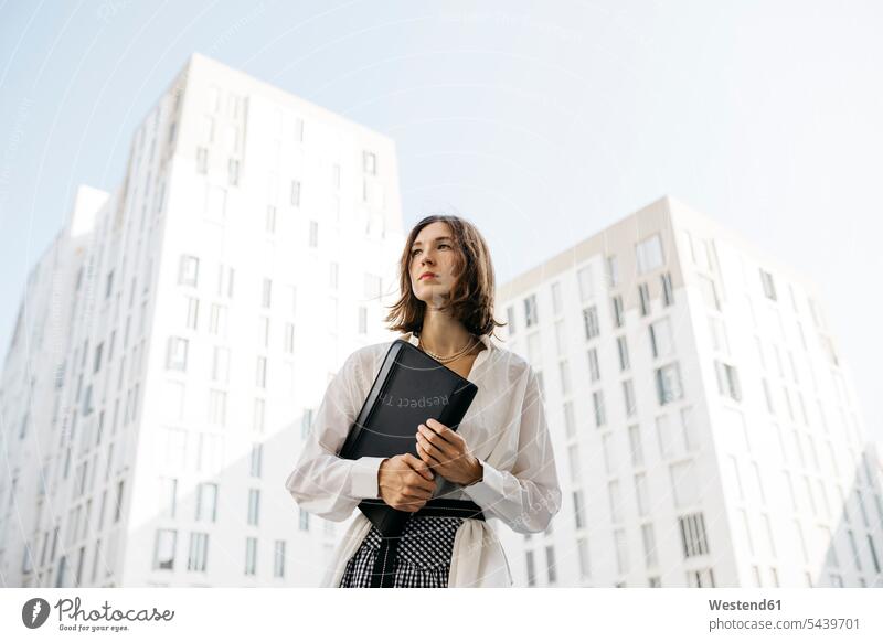Serious woman carryiing folder in the city Occupation Work job jobs profession professional occupation business life business world business person