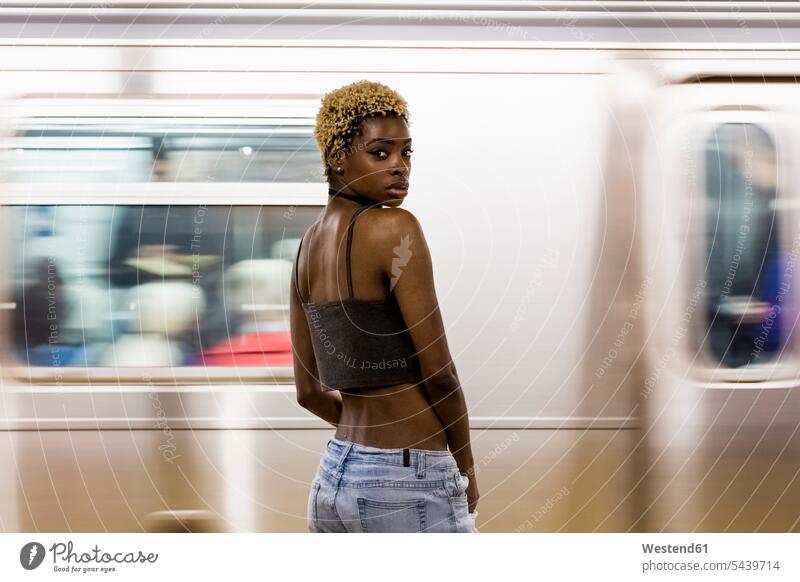 USA, New York City, portrait of woman on subway station platform portraits females women underground station platform Subway Platform Adults grown-ups grownups