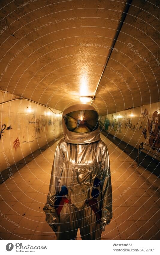 Spaceman in the city at night standing in underpass astronaut astronauts town cities towns spaceman spacemen by night nite night photography astronautics