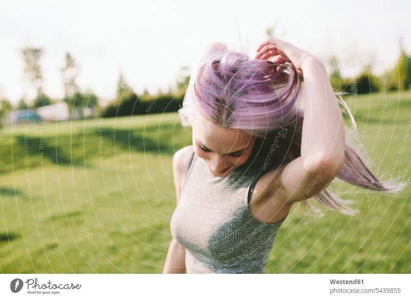 Young woman with pink grey hair dancing on a meadow meadows females women Adults grown-ups grownups adult people persons human being humans human beings dance