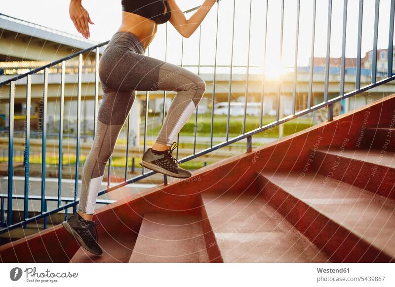 Woman running on stairs in the city Jogging leg legs human leg human legs exercising exercise training practising stairway woman females women fitness sport