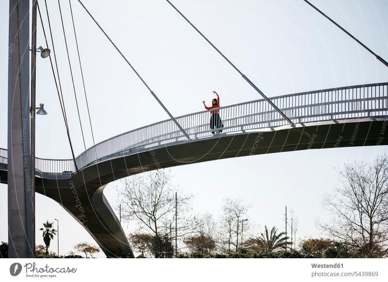 Young contemporary dancer practicing on a footbridge dancing woman females women foot bridges raising arms arm up Hands Raised arm raised Hands Up arms up