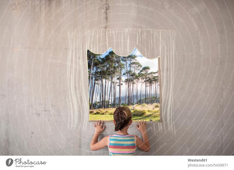 Girl holding a picture of a forest on concrete wall with a chalk drawn border woods forests girl females girls photograph photographs photos concrete walls