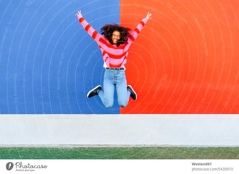 Happy young woman jumping in the air jump in the air Leaping happiness happy females women jumps Adults grown-ups grownups adult people persons human being