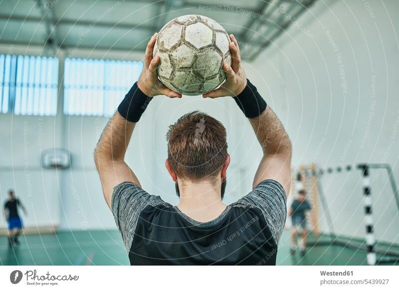 Close-up of indoor soccer player throwing in the ball man men males playing football throw-in football player footballers football players soccer players balls