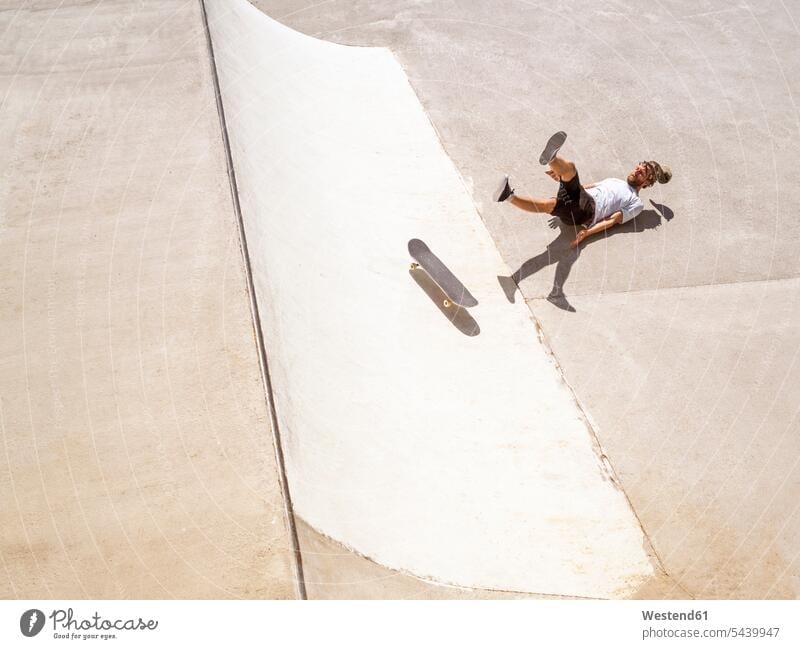Young man skate boarding in skate park skateboarding Skate Board skateboards skatepark Skateboard Park falling tumbling tumble collapse skateboarder skater