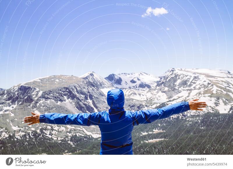 USA, Colorado, Rocky Mountain National Park, Woman looking at the mountains hood hoods hooded jacket exhilaration cheerful impressive monumental journey