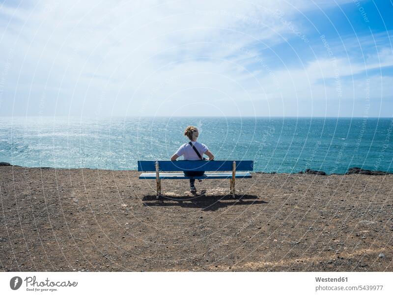 Spain, Canary Islands, Fuerteventura, woman enjoying the sunshine at El Cotillo beach indulgence enjoyment savoring indulging sunlight Sunlit females women