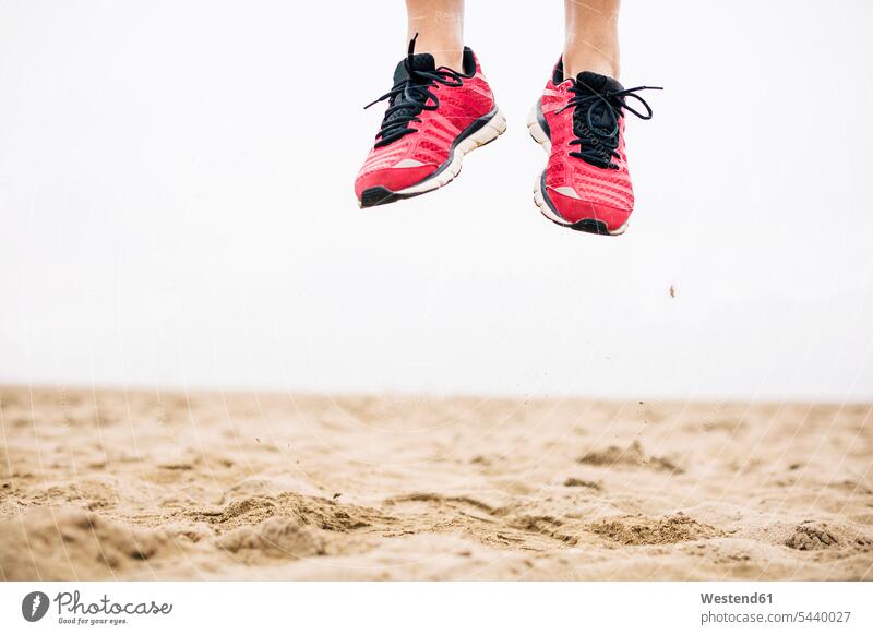 Legs of athlete jumping mid-air in sand exercising exercise training practising copy space fitness Activity active Vitality Verve vigour vigorous agility agile