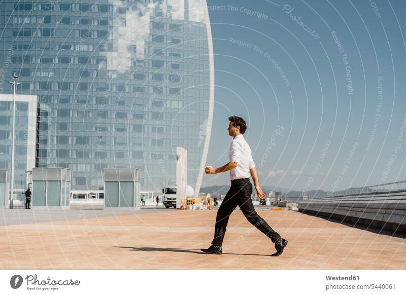 Businessman with takeaway coffee walking in the city Business man Businessmen Business men copy space lifestyle life styles break disposable cup disposable cups