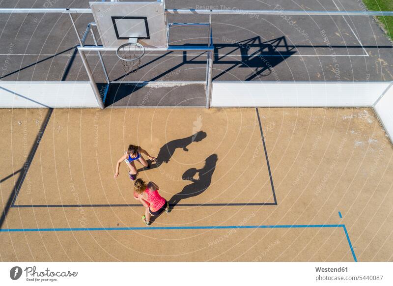 Young women playing basketball, aerial view basketball hoop backboard basketball hoops Basketball sport sports female basketball player