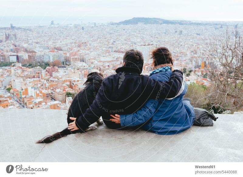 Spain, Barcelona, back view of couple with dog looking at view from Turo de la Rovira mature couple mature couples Looking At View Looking at a view watching