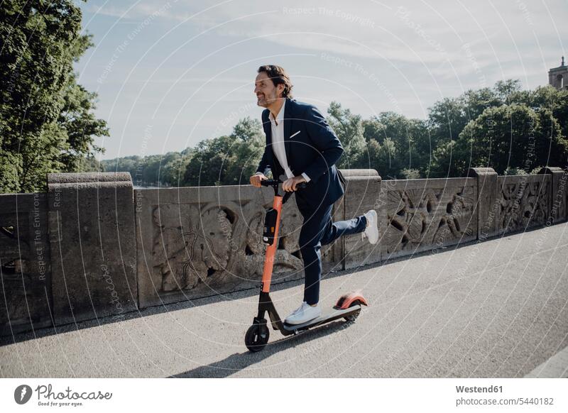 Businessman with e-scooter on a bridge Ability skilled steer commute expressing positivity Occupation Work job jobs profession professional occupation