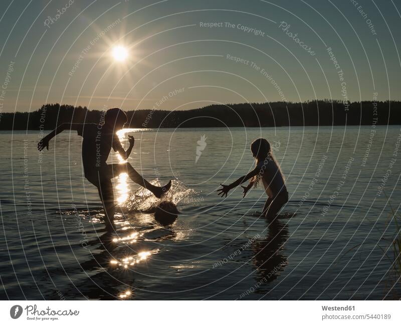 Finland, Southern Savonia, Savonlinna, lake Saimaa, children splashing in water Scandinavia Scandinavian Peninsula Simple Living Downshifting nature Sun
