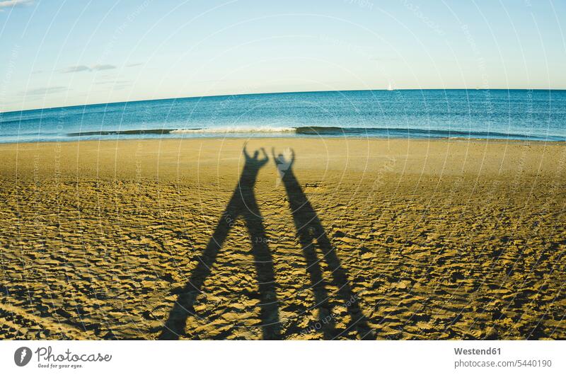 Spain, Valencia, shadow play of two persong on the beach coast coast area seaside coastline Fun funny playing Idea Ideas tranquility tranquillity sunlight